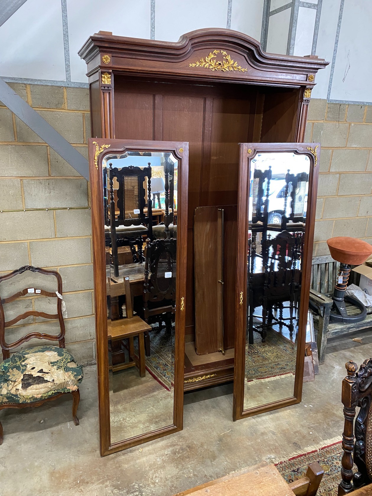 A French gilt metal mounted mirrored armoire, length 134cm, depth 58cm, height 264cm *Please note the sale commences at 9am.